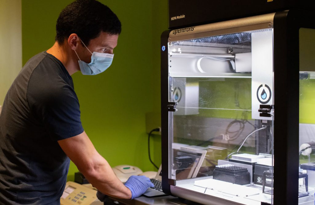 Jeremy Wang operates the Opentrons OT-2 robot, purchased with gifts to the UNC COVID-19 Research Accelerator Fund.