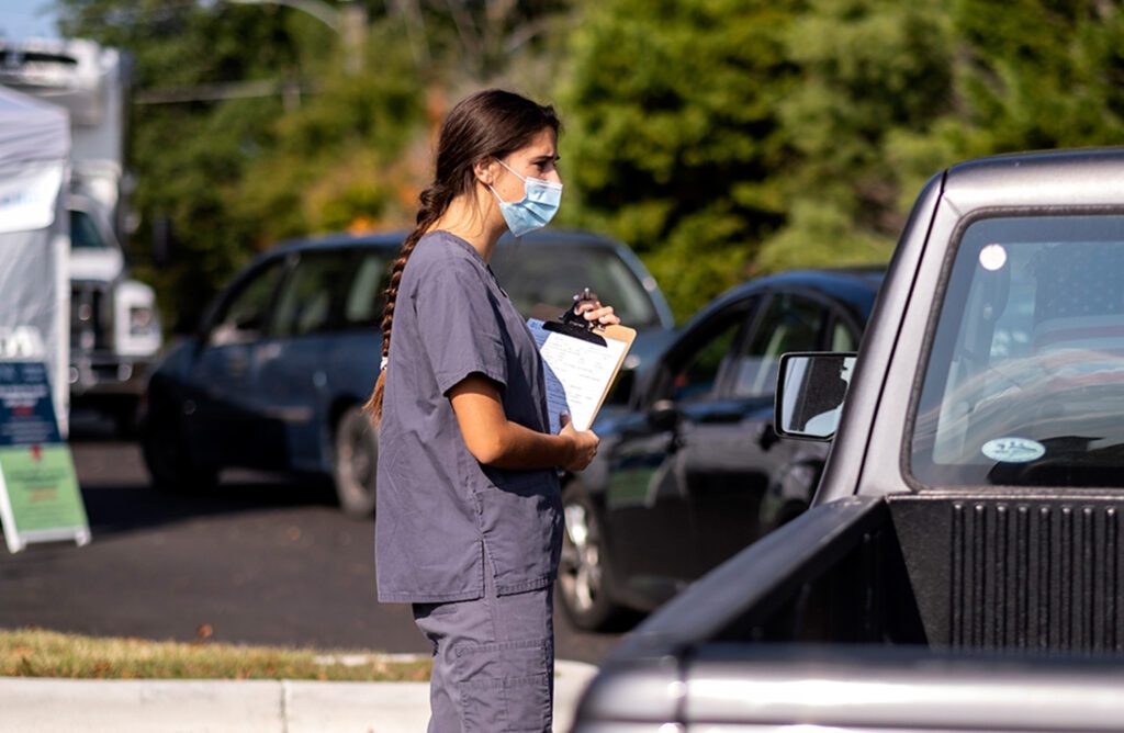 A student works a mobile drive-in health clinic