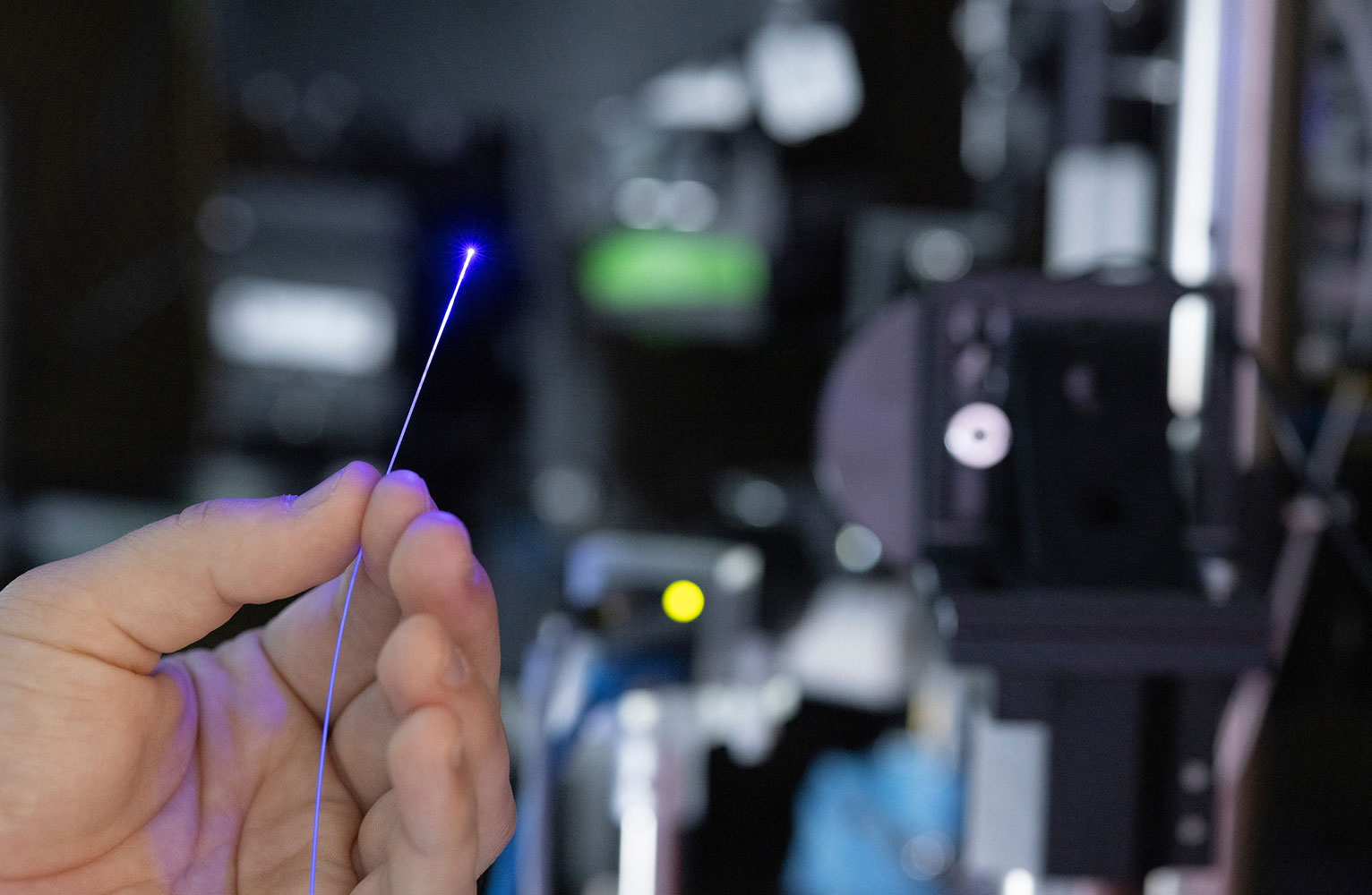 A closeup of a hand holding a beam of light