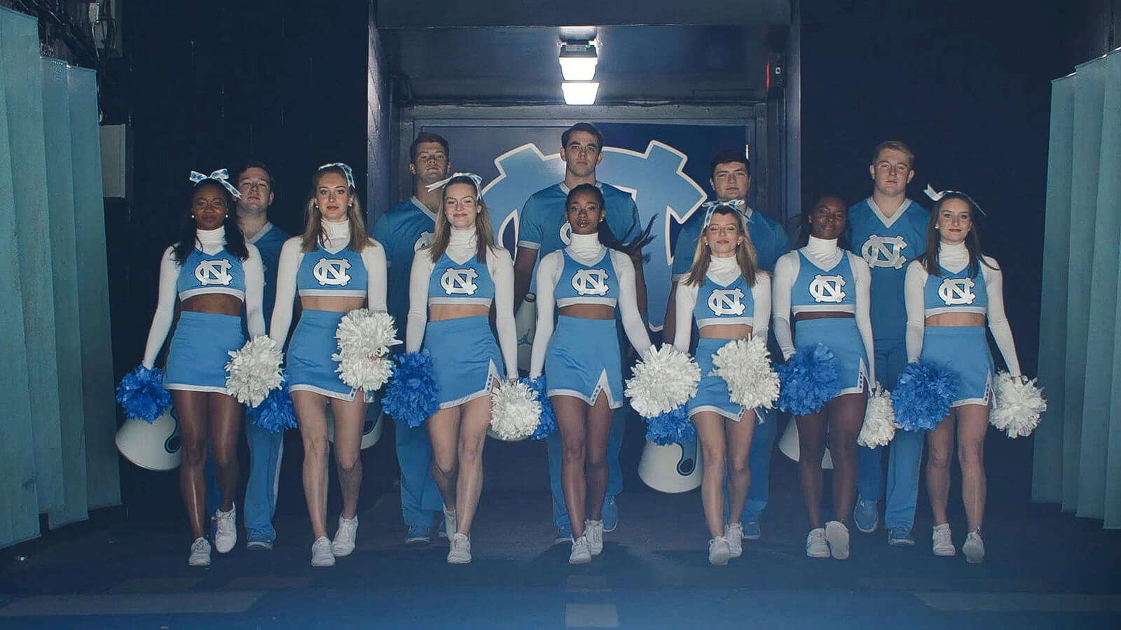 Carolina cheerleaders marching out of a tunnel at Kenan Stadium