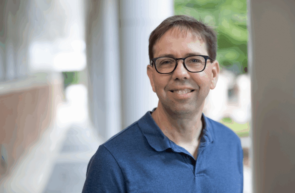 Brian Kuhlman smiling in a blue shirt.