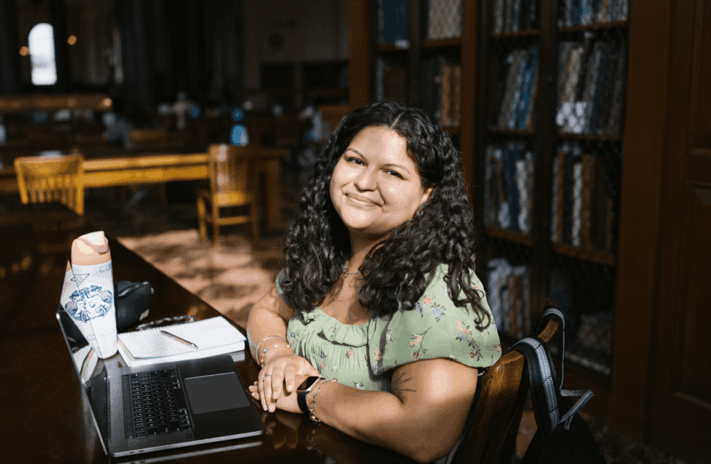 Carolina Covenant Scholar Jennifer Maldonado-Castro '27 sitting in a library