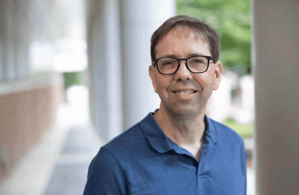 Brian Kuhlman smiling in a blue shirt.