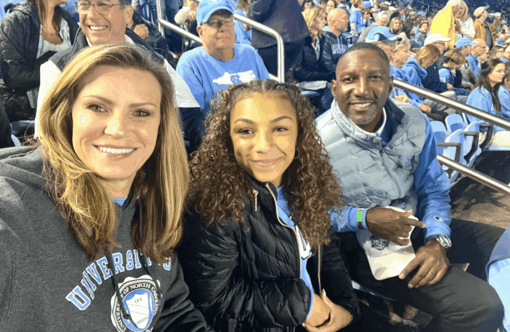 Brandy Barnes (left), her daughter Summer Barnes '27 and husband Chris Barnes at a Carolina Football game.