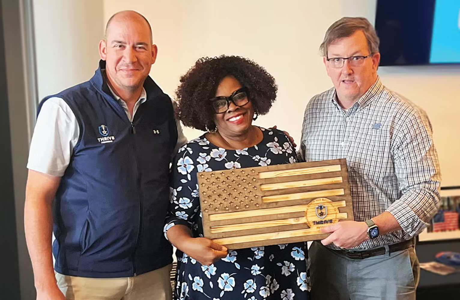 Jason Mihalik, Denise Singleton and Shawn Kane pose for the camera at the inaugural Knott Family Bridging Ceremony. Denise is holding a THRIVE plaque.