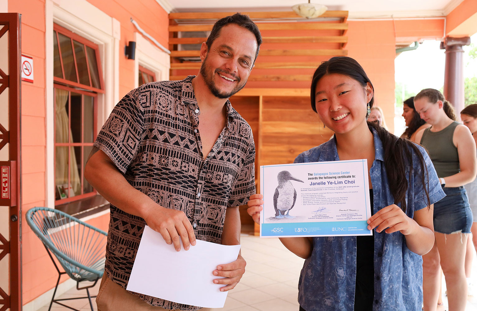 Professor Juan Pablo Munoz and UNC student Janelle Choi pose for the camera; Janelle holds a certificate.