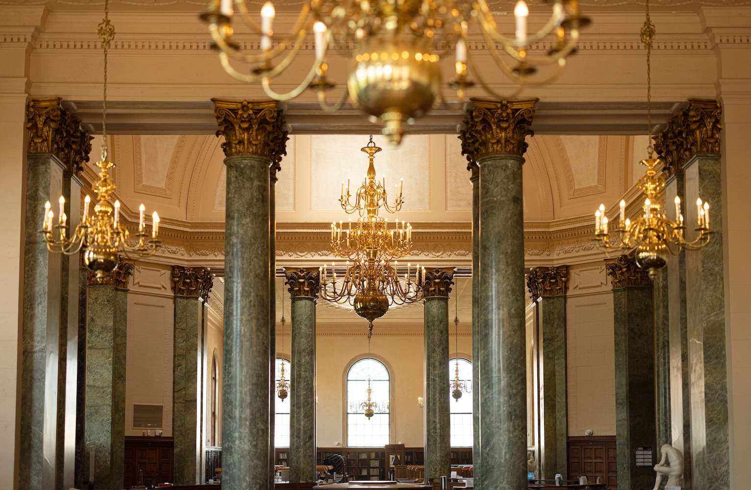 The reading room at Wilson Library, with a chandelier hanging in the foreground.