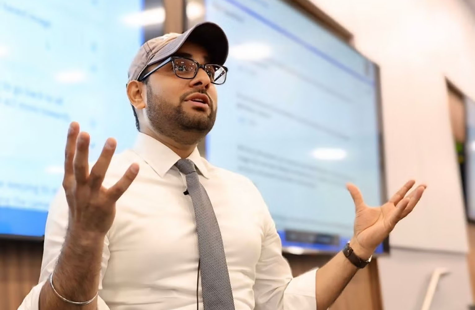 Neil Gaikwad gestures while speaking to students