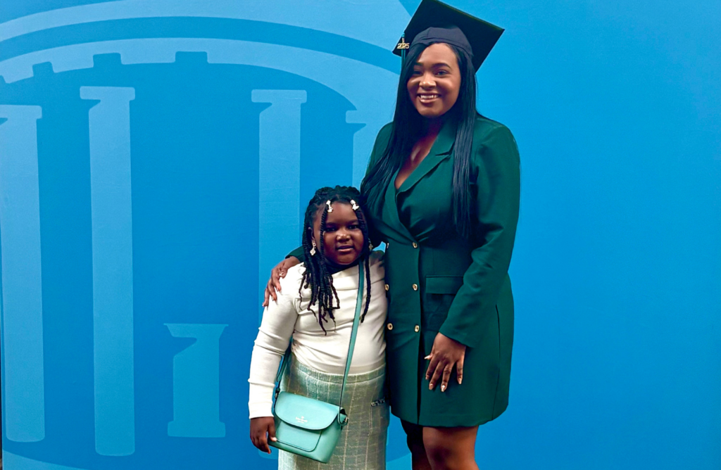 Angelica and her daughter pose with her graduation cap on